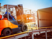 Forklift placing cargo into truck